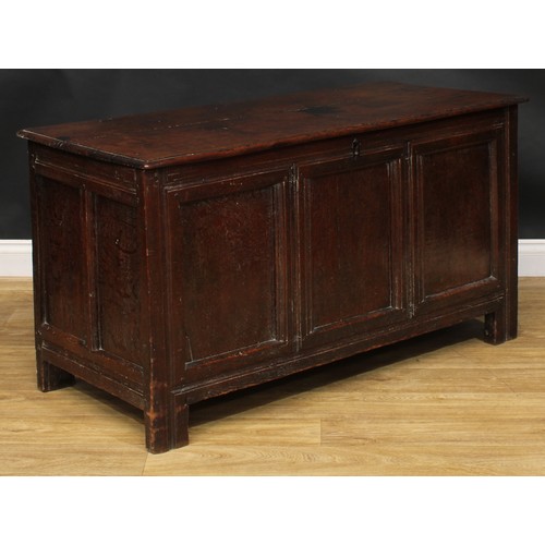 1570 - A 17th century oak blanket chest, hinged top, three panel front, stile feet, 69.5cm high, 129cm wide... 