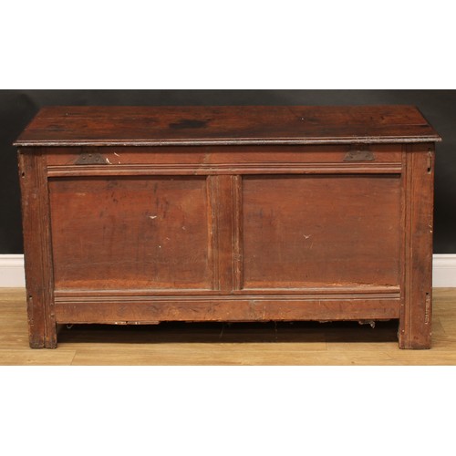 1570 - A 17th century oak blanket chest, hinged top, three panel front, stile feet, 69.5cm high, 129cm wide... 