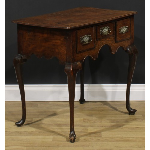 1946 - A George III oak lowboy, oversailing top above three frieze drawers, shaped apron, cabriole legs, po... 