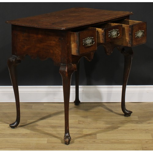 1946 - A George III oak lowboy, oversailing top above three frieze drawers, shaped apron, cabriole legs, po... 