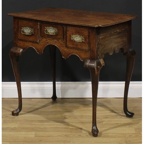 1946 - A George III oak lowboy, oversailing top above three frieze drawers, shaped apron, cabriole legs, po... 