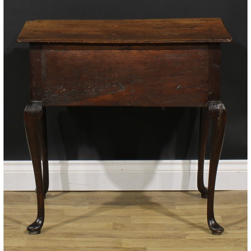 1946 - A George III oak lowboy, oversailing top above three frieze drawers, shaped apron, cabriole legs, po... 