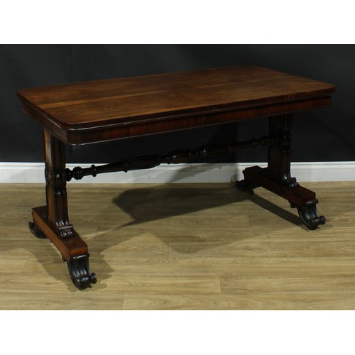 2224 - A William IV rosewood library table, rounded rectangular top, shaped end supports carved and applied... 