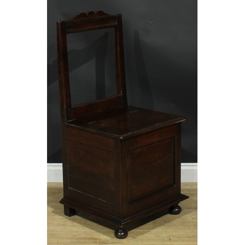 1997 - An 18th century mahogany box chair, rectangular back, hinged seat above a raised and fielded panel, ... 