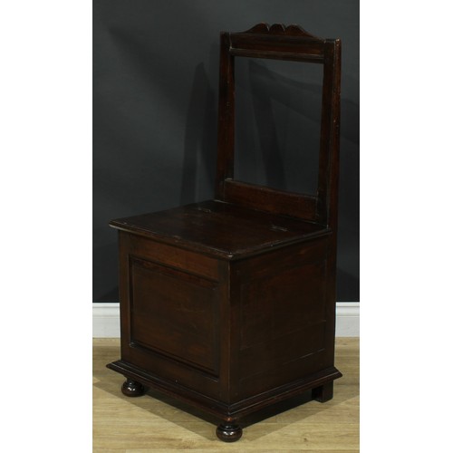 1997 - An 18th century mahogany box chair, rectangular back, hinged seat above a raised and fielded panel, ... 