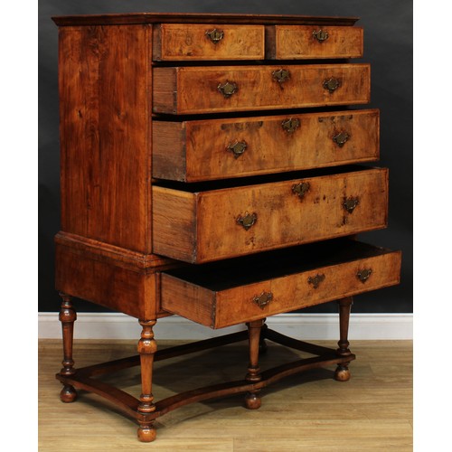 1565 - A ‘Queen Anne’ featherbanded walnut chest on stand, oversailing rectangular top above two short and ... 