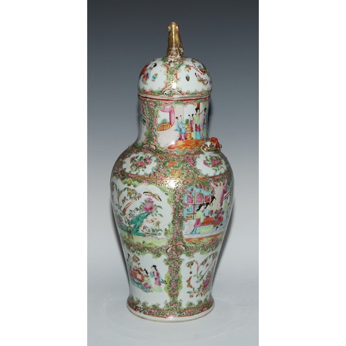 451 - A pair of Cantonese baluster vases and covers, painted in the famille rose palette with figures, bir... 