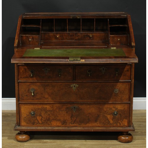 1993 - An 18th century featherbanded walnut bureau, fall front with reading ledge enclosing a tooled and gi... 