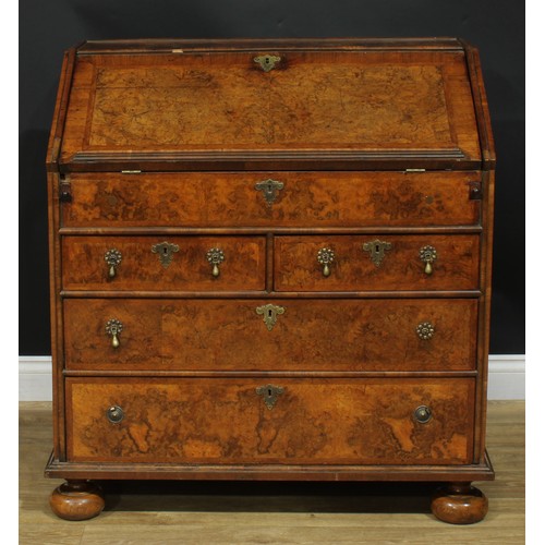 1993 - An 18th century featherbanded walnut bureau, fall front with reading ledge enclosing a tooled and gi... 