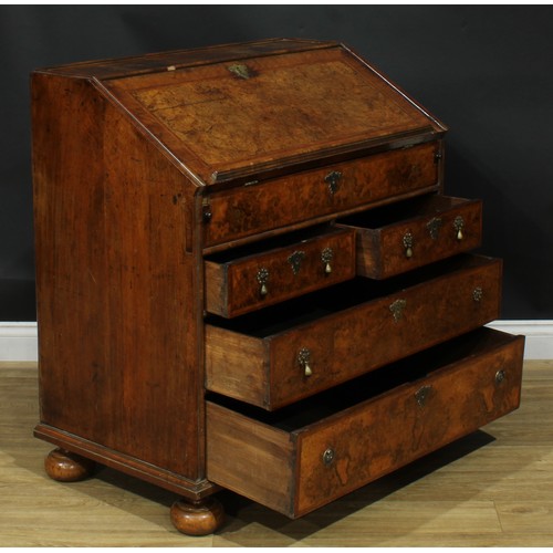 1993 - An 18th century featherbanded walnut bureau, fall front with reading ledge enclosing a tooled and gi... 