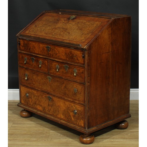 1993 - An 18th century featherbanded walnut bureau, fall front with reading ledge enclosing a tooled and gi... 