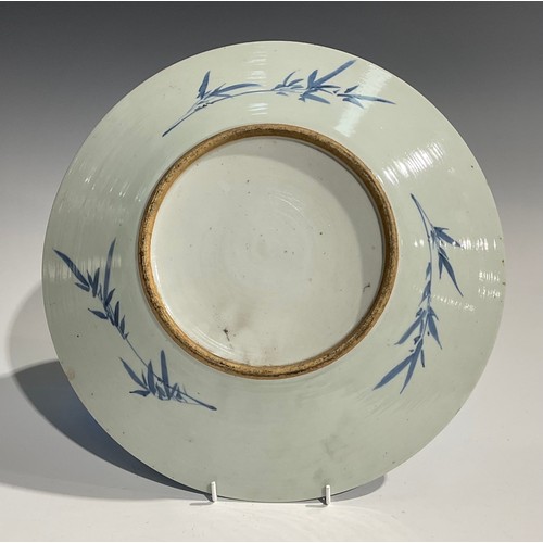 482 - An 18th century Chinese charger, decorated in underglaze blue with scholar and child at a table, c.1... 