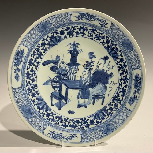 482 - An 18th century Chinese charger, decorated in underglaze blue with scholar and child at a table, c.1... 