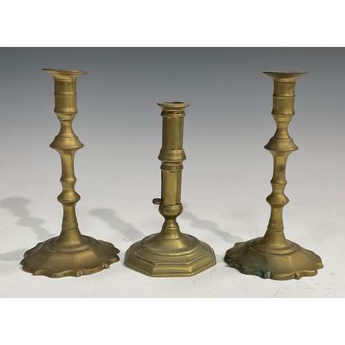 2083 - A pair of George II brass candlesticks, knopped pillars, shaped bases, 21.5cm high, c.1745; another,... 