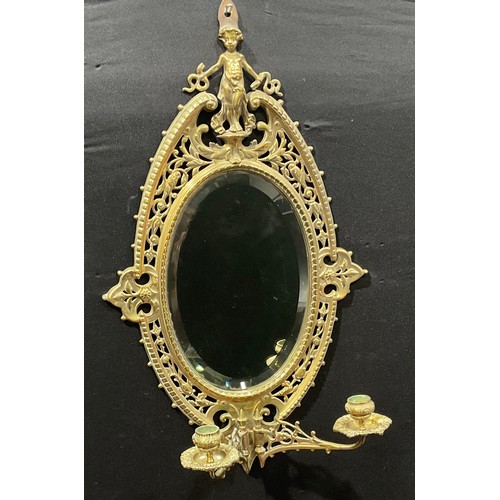 2010 - A 19th century Baroque design brass oval girandole looking glass centred with bevelled mirror plate,... 