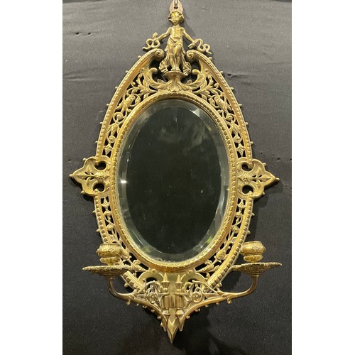 2010 - A 19th century Baroque design brass oval girandole looking glass centred with bevelled mirror plate,... 