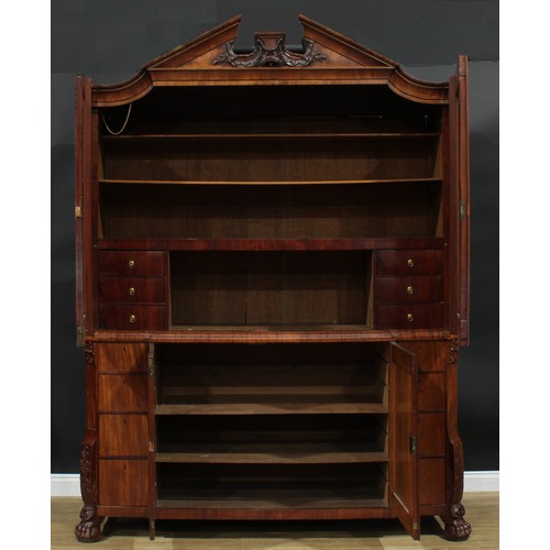 1585 - A 19th century Dutch mahogany enclosed library cabinet, broken-arch pediment above a pair of panel d... 