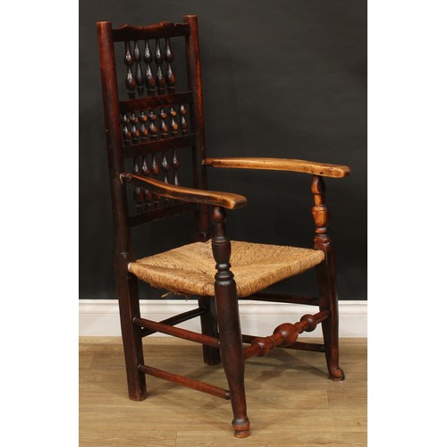 1595 - A 19th century fruitwood and elm spindleback elbow chair, rush seat, turned fore stretcher, 105cm hi... 