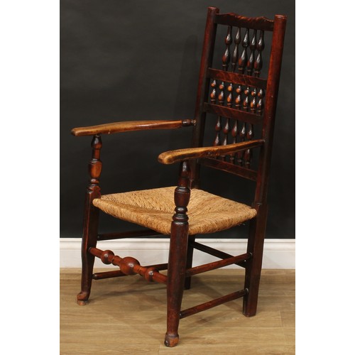 1595 - A 19th century fruitwood and elm spindleback elbow chair, rush seat, turned fore stretcher, 105cm hi... 