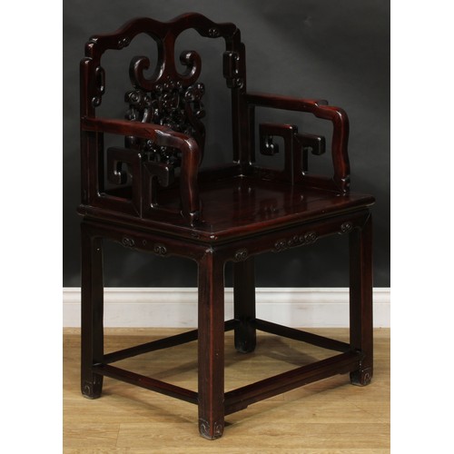 1652 - A Chinese hardwood armchair, the cresting rail, splat and sides carved with a bat, scrolls and trell... 