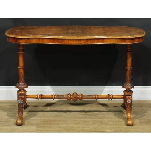 2293 - A Victorian walnut shaped serpentine centre table, quarter-veneered top, turned end supports and str... 