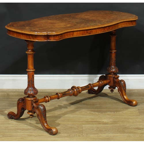 2293 - A Victorian walnut shaped serpentine centre table, quarter-veneered top, turned end supports and str... 