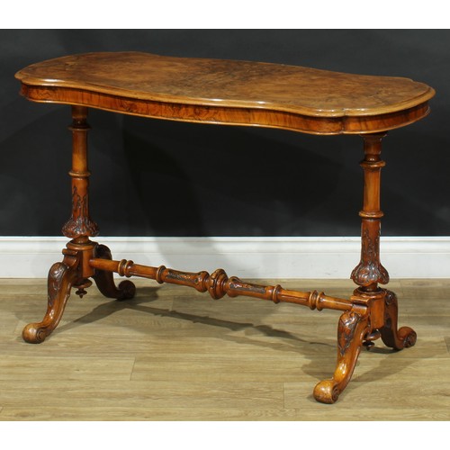 2293 - A Victorian walnut shaped serpentine centre table, quarter-veneered top, turned end supports and str... 