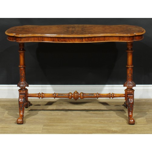 2293 - A Victorian walnut shaped serpentine centre table, quarter-veneered top, turned end supports and str... 