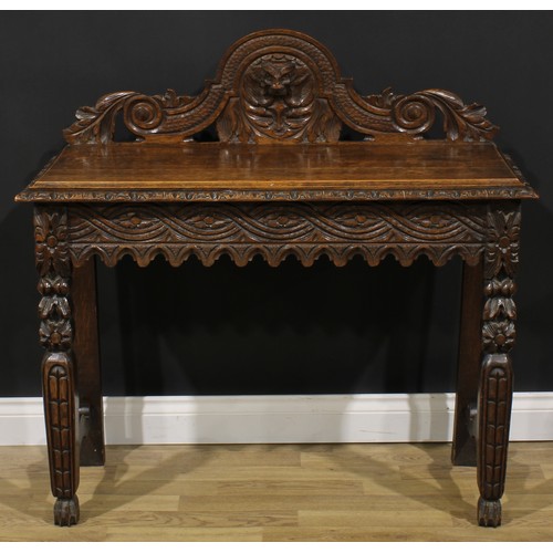 1958 - A late Victorian oak side or serving table, shaped half-gallery centred by a Green Man mask, oversai... 