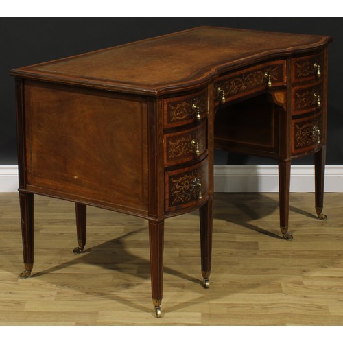 2562 - A Sheraton Revival satinwood crossbanded mahogany and marquetry inverted shaped serpentine desk, by ... 