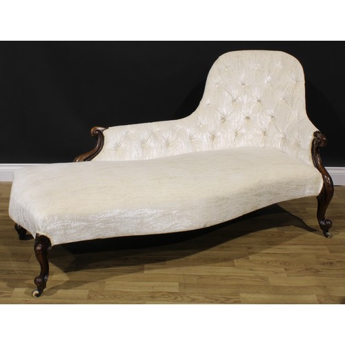 2286 - A Victorian walnut button-back chaise longue, stuffed-over upholstery, carved scroll ends and cabrio... 