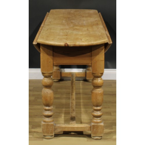 2397 - An Irish pine wake table, oval top with fall leaves, turned legs, H-stretcher, 79cm high, 200cm long... 