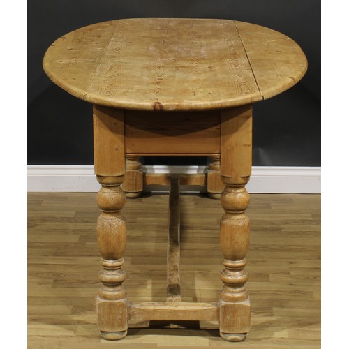 2397 - An Irish pine wake table, oval top with fall leaves, turned legs, H-stretcher, 79cm high, 200cm long... 