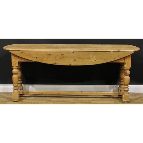 2397 - An Irish pine wake table, oval top with fall leaves, turned legs, H-stretcher, 79cm high, 200cm long... 