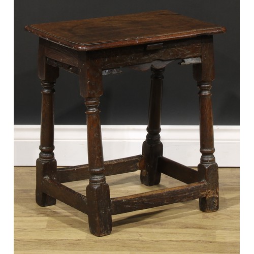 2003 - An 18th century oak joint stool, rounded rectangular seat, shaped apron, turned and blocked legs, 50... 