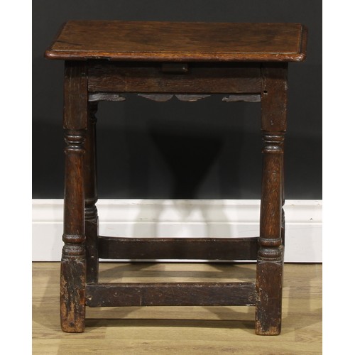 2003 - An 18th century oak joint stool, rounded rectangular seat, shaped apron, turned and blocked legs, 50... 