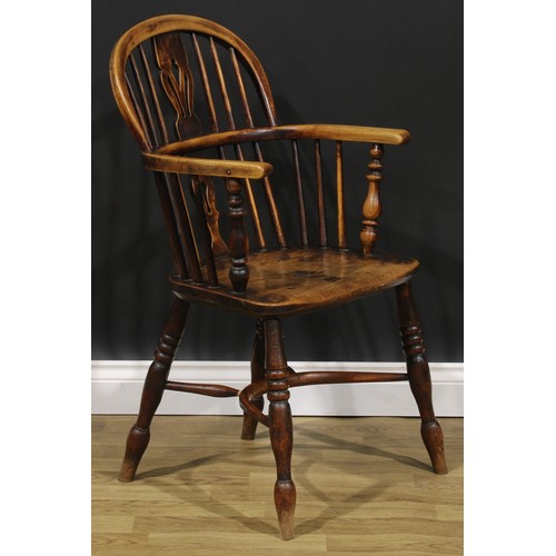 1589 - A 19th century East Midlands ash and elm Windsor elbow chair, low hoop back, shaped and pierced spla... 