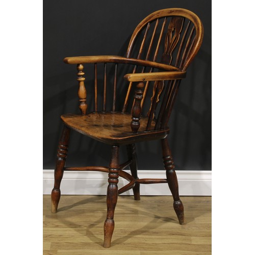 1589 - A 19th century East Midlands ash and elm Windsor elbow chair, low hoop back, shaped and pierced spla... 