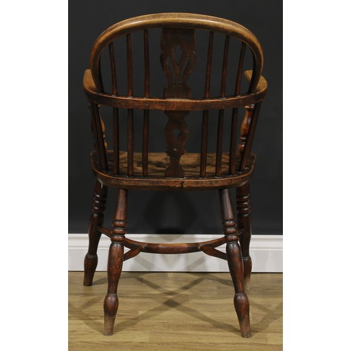 1589 - A 19th century East Midlands ash and elm Windsor elbow chair, low hoop back, shaped and pierced spla... 