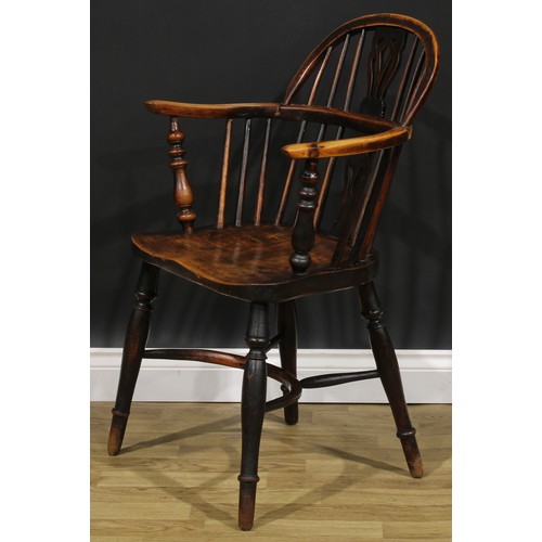 1590 - A 19th century East Midlands yew, ash and elm Windsor elbow chair, low hoop back, shaped and pierced... 