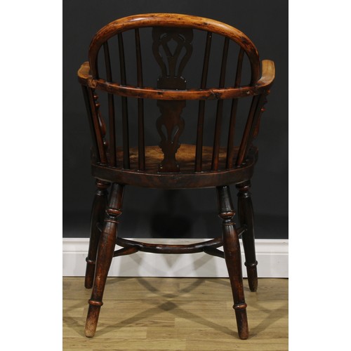 1590 - A 19th century East Midlands yew, ash and elm Windsor elbow chair, low hoop back, shaped and pierced... 