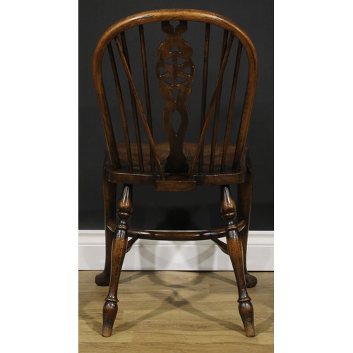 2375 - A set of four beech and elm wheelback Windsor kitchen chairs, by Glenister, High Wycombe, crinoline ... 