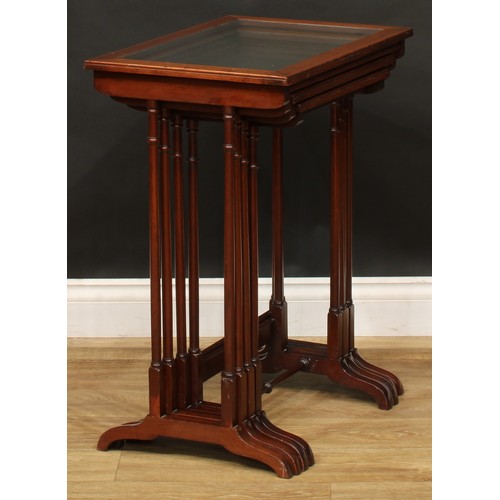 2373 - A set of Edwardian mahogany quartetto tables, each plateau with inset glass panel, outlined througho... 