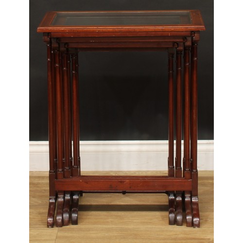 2373 - A set of Edwardian mahogany quartetto tables, each plateau with inset glass panel, outlined througho... 