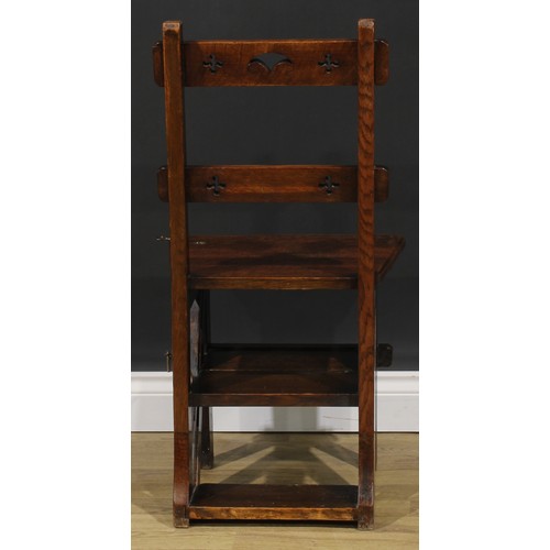 2654 - An Arts & Crafts oak metamorphic library step chair, rectangular cresting and mid rail pierced with ... 