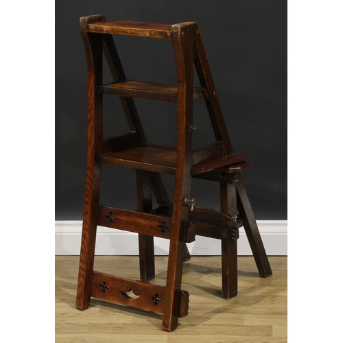 2654 - An Arts & Crafts oak metamorphic library step chair, rectangular cresting and mid rail pierced with ... 