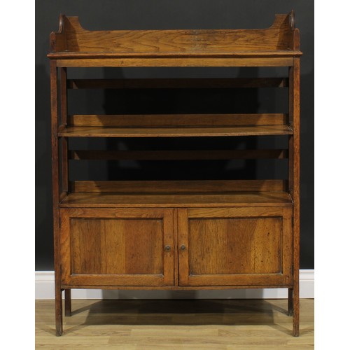 2328 - An Arts & Crafts oak bookcase, three-quarter gallery above open shelves and a pair of panel doors, s... 