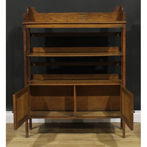 2328 - An Arts & Crafts oak bookcase, three-quarter gallery above open shelves and a pair of panel doors, s... 