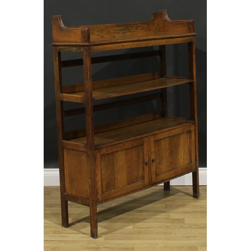 2328 - An Arts & Crafts oak bookcase, three-quarter gallery above open shelves and a pair of panel doors, s... 