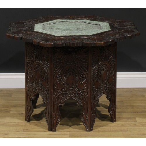 2641 - An Anglo-Indian teak folding Hoshiarpur table, carved throughout with peacocks and trailing stems, o... 